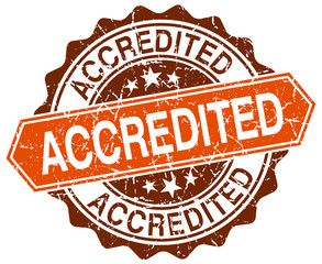 accredited orange round grunge stamp on white