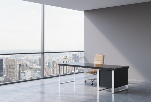 A workplace in a modern panoramic office, New York city view from the windows. A concept of financial consulting services. A brown leather chair and a black table. 3D rendering.
