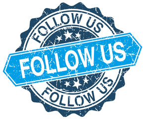 follow us blue round grunge stamp on white