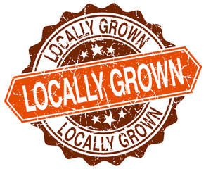 locally grown orange round grunge stamp on white