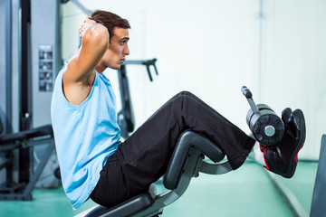 Fototapeta na wymiar Man exercising in gym doing sit ups