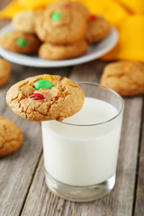 Cookies with colorful candy on grey wooden background
