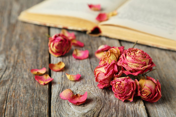 Dried roses on grey wooden background