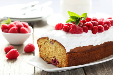 Raspberry cake on plate on grey wooden background