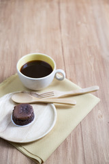 Hokkaido chocolate cheesecake with coffee cup with wooden backgr