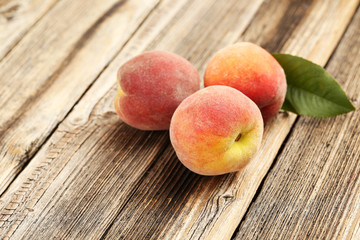 Fototapeta na wymiar Ripe peaches fruit on a brown wooden background