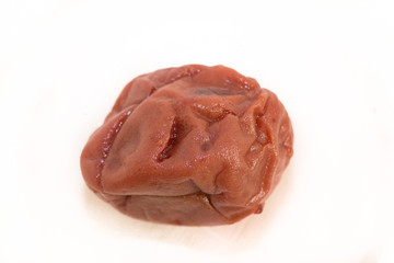 Pickled plum also known as ume boshi on isolated white background