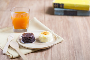 Hokkaido cheesecake with fruit juice with wooden background
