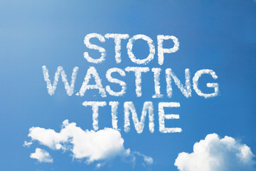 Naklejka na ściany i meble stop wasting time cloud word on sky