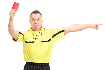 Angry football referee showing a red card and pointing with his