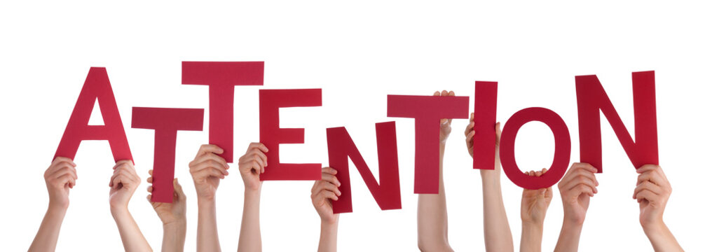 Many People Hands Holding Red Word Attention