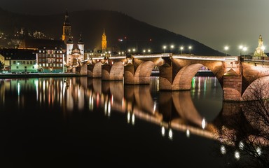 heidelbergs old city at night reflecting in the neckar - obrazy, fototapety, plakaty