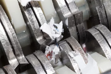 Fotobehang Jammed shredder scraps between paper shredder blades  © Miyuki Satake