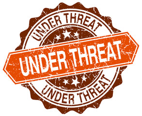 under threat orange round grunge stamp on white