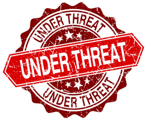 under threat red round grunge stamp on white