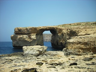 The famous rock formation called "The Azure Window" - limestone natural arch on the Maltese island of Gozo, on a sunny summer day.
