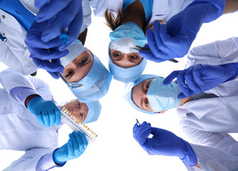 Surgeons team, man and woman wearing protective uniforms,caps