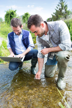 Scientist and biologist working together on water analysis