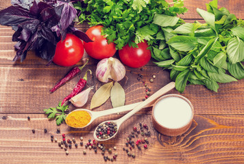 Raw vegetables, basil and spices on the wood table