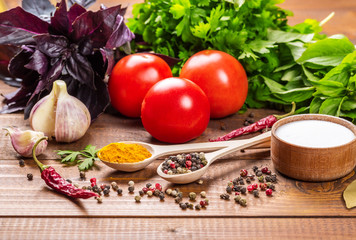 Raw vegetables, basil and spices on the wood table