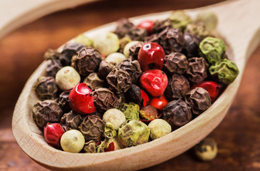 Pepper seeds in wooden spoon on wood table