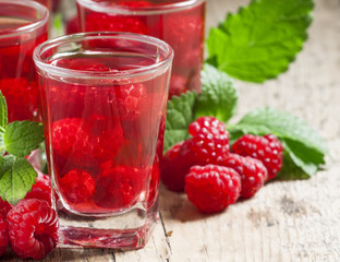 Red refreshing cocktail with raspberry and mint, selective focus