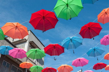 Fototapeta na wymiar Streets are decorated with colorful umbrellas. 