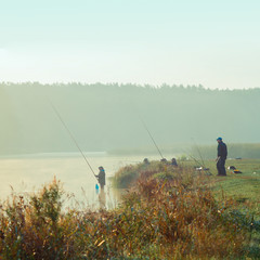 Obraz na płótnie Canvas Fisherman fishing. A fisherman catches a fish in the morning