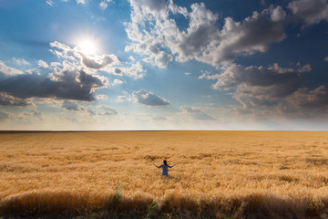 Girl among a field of wheat