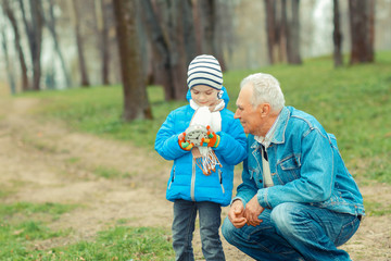 Grandfather showing grandson vintage watches. The grandfather tells his grandson about time.