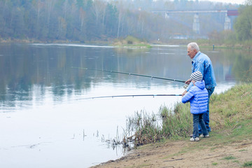 Fototapeta na wymiar Grandfather and grandson are fishing