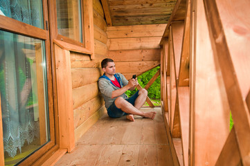 Young man using mobile phone. Mountains. Communication concept. 