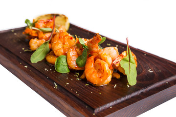 roasted hulled shrimps with leafs on dark wooden