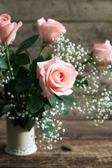 Still life: pink roses and gypsophila paniculata in a vase 