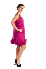 Young and sexy woman model in pink dress posing