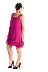 Young and sexy woman model in pink dress posing