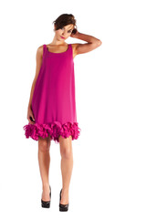 Young and sexy woman model in pink dress posing