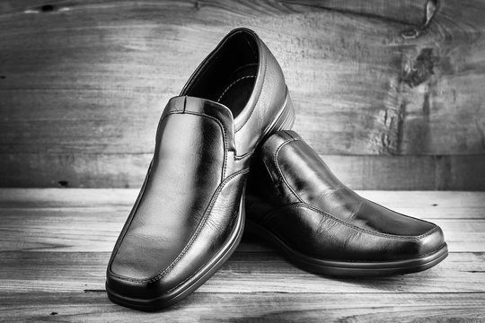Classic black men's shoes on wood background (Black and White)