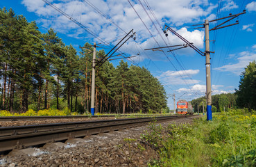 Fototapeta premium Electric train goes by rail, summer, countryside
