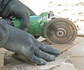 worker cutting decorative stone used for facades in construction site
