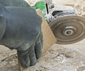 worker cutting decorative stone used for facades in construction site