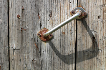 Door handle on an old wooden board