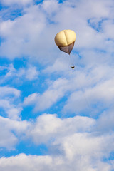 Big white balloon over a white clouds
