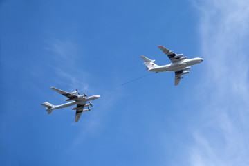 Military transport plane Il-78 refueling tankers and Tu-95 turboprop strategic bomber in flight