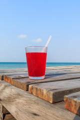 Strawberry juice on Wooden pathway near the beach