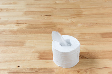 Toilet paper on wooden background.