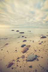  Sunrise over the sea. Beautiful long exposure landscape of rocky shore