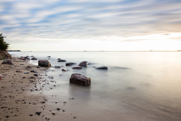  Sunrise over the sea. Beautiful long exposure landscape of rocky shore