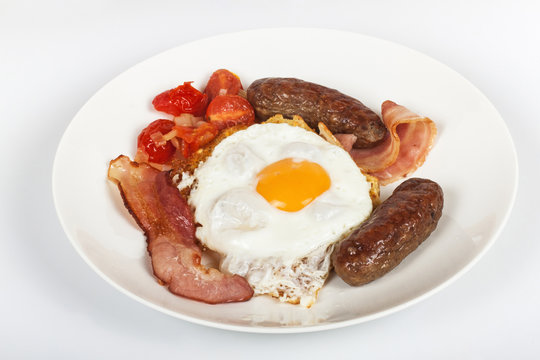 Breakfast of Egg on Toast with Bacon, Sausages and Tomato