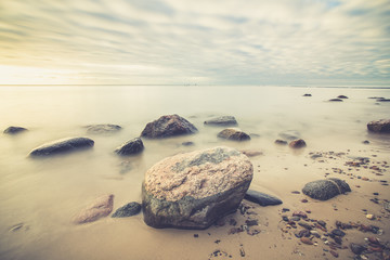  Sunrise over the sea. Beautiful long exposure landscape of rocky shore